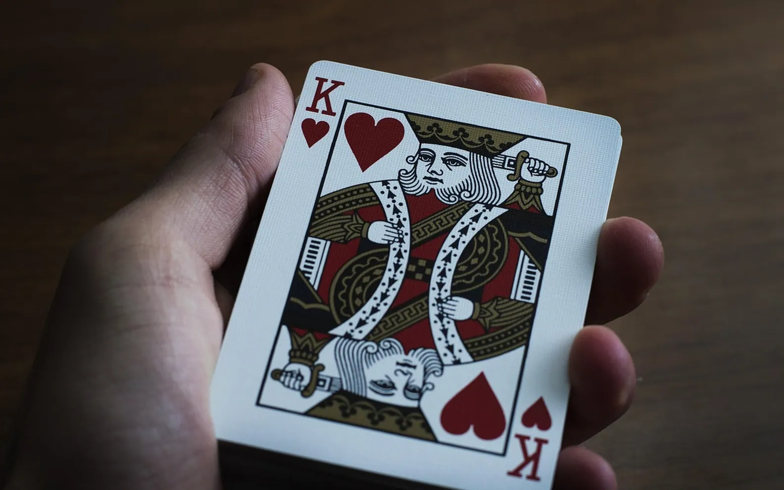 Hand, playing cards and paper