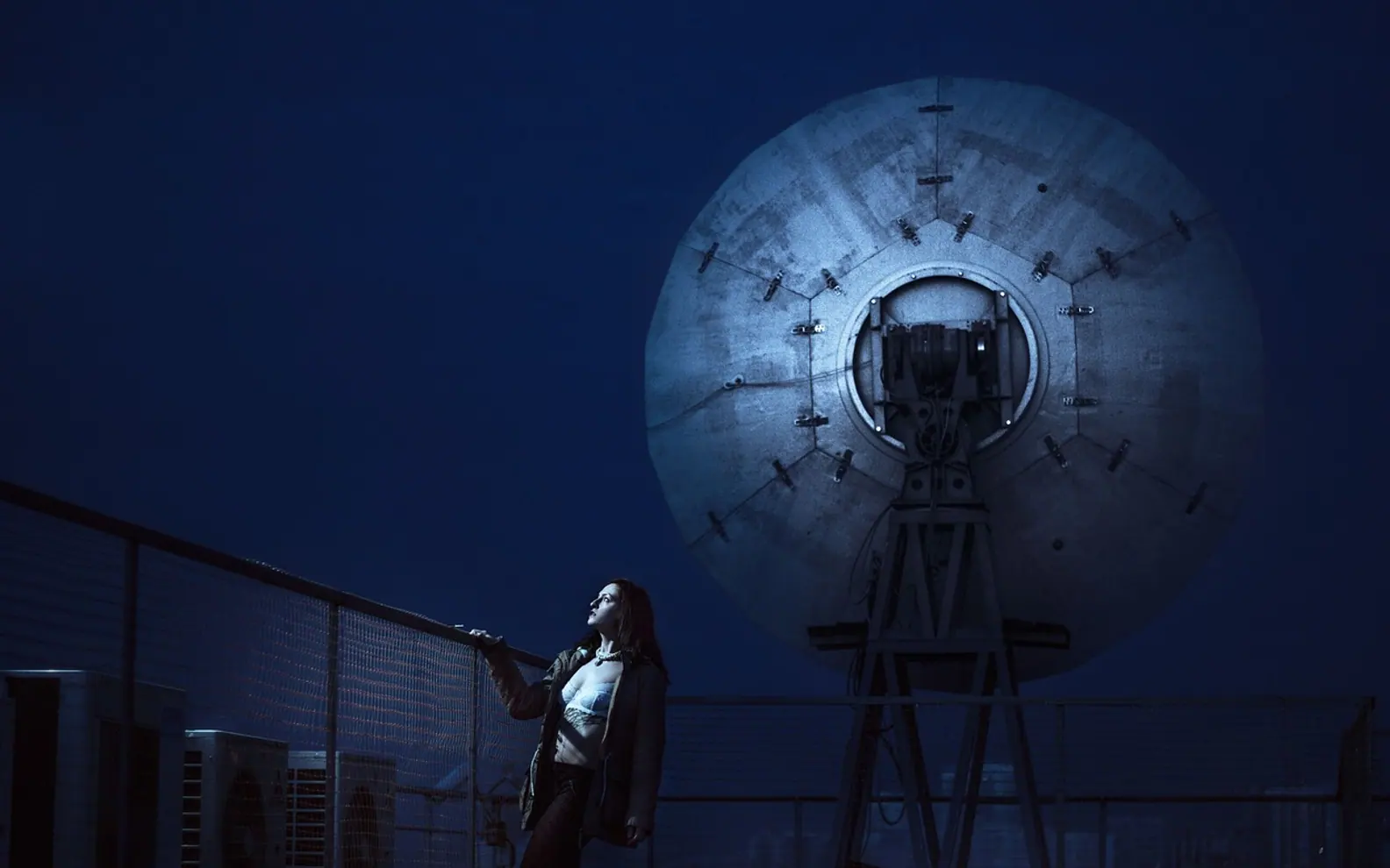 Young woman, satellite dishes and antennas